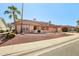 Single-story home with tile roof, desert landscaping, and a two-car garage at 13917 W Pavillion Dr, Sun City West, AZ 85375