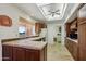 L-shaped kitchen with tile countertops and wood cabinets at 13917 W Pavillion Dr, Sun City West, AZ 85375