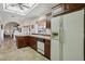 Spacious kitchen with wood cabinets, tile flooring, and modern appliances at 13917 W Pavillion Dr, Sun City West, AZ 85375