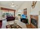 Living room with fireplace, vaulted ceilings and view of backyard patio at 13917 W Pavillion Dr, Sun City West, AZ 85375