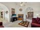 Comfortable living room with a fireplace and built-in shelving at 13917 W Pavillion Dr, Sun City West, AZ 85375