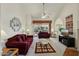 Living room with a fireplace, vaulted ceiling and access to a patio at 13917 W Pavillion Dr, Sun City West, AZ 85375