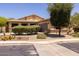 Single-story home with landscaped front yard and two-car garage at 14960 W Cottonwood St, Surprise, AZ 85374