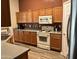 Well-equipped kitchen featuring wood cabinets and an electric range at 14960 W Cottonwood St, Surprise, AZ 85374