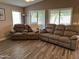 Relaxing living room with two reclining couches and large windows at 14960 W Cottonwood St, Surprise, AZ 85374