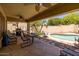 Patio with outdoor kitchen, seating, and pool view at 14960 W Cottonwood St, Surprise, AZ 85374