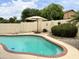 Relaxing kidney-shaped pool with patio and landscaping at 14960 W Cottonwood St, Surprise, AZ 85374