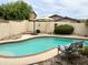 Kidney shaped pool with brick coping and a patio at 14960 W Cottonwood St, Surprise, AZ 85374