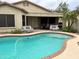 Large kidney shaped pool, brick patio, and seating area at 14960 W Cottonwood St, Surprise, AZ 85374