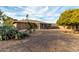 Landscaped backyard featuring gravel, trees, and a patio at 16033 N 110Th Ave, Sun City, AZ 85351