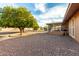 Sunny backyard with gravel and a screened patio at 16033 N 110Th Ave, Sun City, AZ 85351