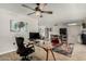 Bright dining area with wood-look floors and adjacent workspace at 16033 N 110Th Ave, Sun City, AZ 85351