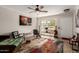 Open living room with wood-look floors and colorful rug at 16033 N 110Th Ave, Sun City, AZ 85351