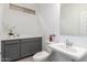 Clean and modern bathroom with gray vanity and white fixtures at 16917 W Jenan Dr, Surprise, AZ 85388