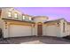 Two-story house with a three-car garage and attractive landscaping at 16917 W Jenan Dr, Surprise, AZ 85388