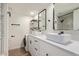 Modern bathroom with dual vanity sinks, black hardware, and stylish fixtures at 1702 W Tuckey Ln # 123, Phoenix, AZ 85015