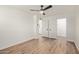 Bedroom has wood-look floors, white walls, ceiling fan, closet and door leading to a bathroom at 1702 W Tuckey Ln # 123, Phoenix, AZ 85015