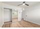 Bright bedroom with light walls, wood-look floors, and a mirrored sliding-door closet at 1702 W Tuckey Ln # 123, Phoenix, AZ 85015