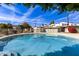 Relaxing community pool surrounded by comfortable lounge chairs and lush greenery, perfect for summertime at 1702 W Tuckey Ln # 123, Phoenix, AZ 85015