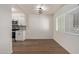 Bright dining area featuring laminate flooring, a window, and a view into the kitchen at 1702 W Tuckey Ln # 123, Phoenix, AZ 85015