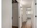 Bright hallway with wood-look floors and white walls leads to a closet and other rooms at 1702 W Tuckey Ln # 123, Phoenix, AZ 85015