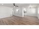 Open-concept living room featuring laminate floors and a view into the bright kitchen at 1702 W Tuckey Ln # 123, Phoenix, AZ 85015