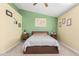 Cozy bedroom featuring neutral carpeting, a ceiling fan, and colorful accents on the walls at 17347 W Statler St, Surprise, AZ 85388