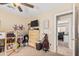 Bedroom featuring carpet, a ceiling fan, a TV, and doorway to another room at 17347 W Statler St, Surprise, AZ 85388