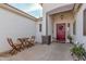 Inviting front porch area with seating, a decorative door, and a well-maintained entryway at 17347 W Statler St, Surprise, AZ 85388