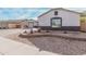 Landscaped front yard with decorative planters and a view of the home's facade and three-car garage at 17347 W Statler St, Surprise, AZ 85388