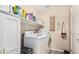 Functional laundry room with white washer, dryer, and extra storage cabinet at 17347 W Statler St, Surprise, AZ 85388