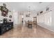 Open-concept living room with neutral tones, tile flooring, and an adjacent dining area for modern living at 17347 W Statler St, Surprise, AZ 85388