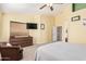 Inviting main bedroom with a ceiling fan, a window with blinds, and neutral carpeting at 17347 W Statler St, Surprise, AZ 85388