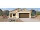 Tan house with brown garage door and desert landscaping at 1775 W Sheridan Ave, Apache Junction, AZ 85120