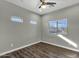 Bright bedroom with wood floors and multiple windows at 18651 E Superstition Dr, Queen Creek, AZ 85142