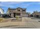 Two story house exterior with stone accents, large windows and double car garage at 18651 E Superstition Dr, Queen Creek, AZ 85142