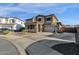 Two story house exterior with stone accents, large windows and double car garage at 18651 E Superstition Dr, Queen Creek, AZ 85142