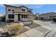 Two story house exterior with stone accents, large windows and double car garage at 18651 E Superstition Dr, Queen Creek, AZ 85142