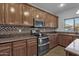 Kitchen with stainless steel appliances and wood cabinetry at 18651 E Superstition Dr, Queen Creek, AZ 85142