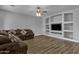 Living area with built-in shelving and hardwood floors at 18651 E Superstition Dr, Queen Creek, AZ 85142