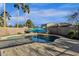 Clear blue kidney shaped pool with patio and palm trees at 18651 E Superstition Dr, Queen Creek, AZ 85142