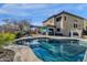 Relaxing kidney shaped pool with patio and covered seating area at 18651 E Superstition Dr, Queen Creek, AZ 85142