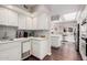 Bright kitchen boasts white cabinets, granite counters, and a view into the adjacent living area at 19127 E Wiki Way, Rio Verde, AZ 85263