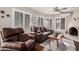 Relaxing living room with a cozy fireplace and leather furniture at 19127 E Wiki Way, Rio Verde, AZ 85263