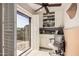 Home office with built-in shelving, a desk, and patio access at 19127 E Wiki Way, Rio Verde, AZ 85263