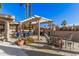 Lush patio with pergola, fire pit, and comfortable seating at 19127 E Wiki Way, Rio Verde, AZ 85263