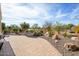 Landscaped backyard with a brick patio at 20642 N 268Th Dr, Buckeye, AZ 85396