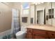 Guest bathroom with tub shower combo, wood vanity, and mirror at 20642 N 268Th Dr, Buckeye, AZ 85396