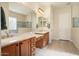 Elegant bathroom with dual vanities, a large mirror, and a walk-in shower at 20642 N 268Th Dr, Buckeye, AZ 85396