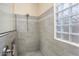 Clean bathroom with a walk-in shower, neutral tile and a window at 20642 N 268Th Dr, Buckeye, AZ 85396